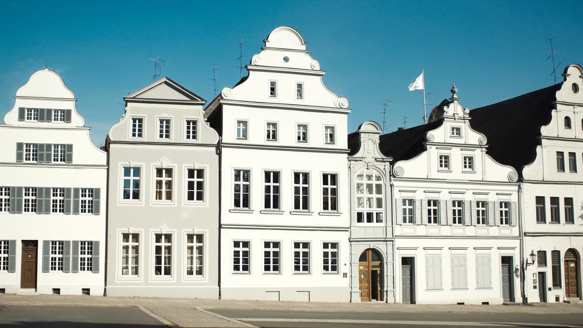 Bunte Bürgerhäuser mit farbigen Fensterläden in einer Altstadt
